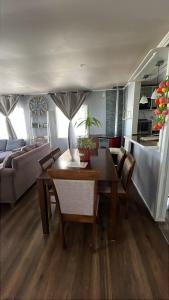 a living room with a dining table and a couch at Cabaña en Ancud in Ancud