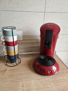 a red blender sitting on top of a wooden floor at L'Instant Bourguignon in Montceau-les-Mines