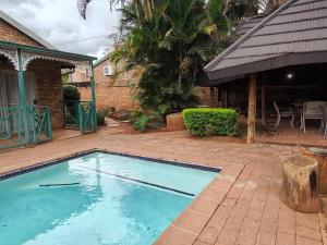a swimming pool in front of a house at B&O's Place in Pretoria
