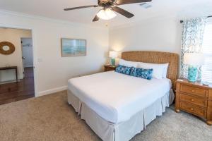 a bedroom with a bed and a ceiling fan at Hello Sunshine in Santa Rosa Beach +68 photos