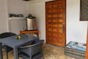 a room with a table and chairs and a door at Poe Guesthouse in Avatoru +7 photos