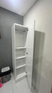 a white cabinet in a room with a toilet at Prestige Apartments C - Affordable Studio Near Sambil Shopping Mall with Fast WiFi in Willemstad