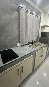 a kitchen with a sink and a counter top at Prestige Apartments C - Affordable Studio Near Sambil Shopping Mall with Fast WiFi in Willemstad