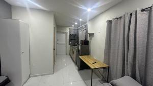 a room with a kitchen with a table and a refrigerator at Prestige Apartments C - Affordable Studio Near Sambil Shopping Mall with Fast WiFi in Willemstad