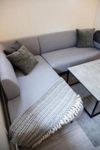 a living room with a couch and a table at Modern apartment near train station H77A in Narvik
