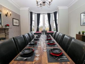 a long table with plates and wine glasses on it at Rocklands in Penrith
