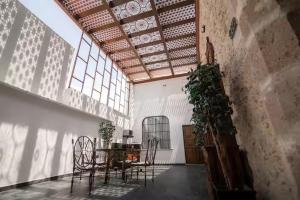 a dining room with a table and chairs in a building at Casa Alzate in Morelia