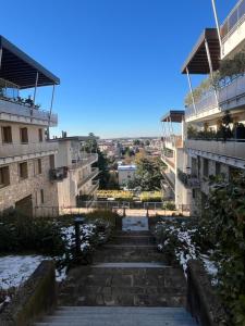 a stairway between two buildings with snow on the ground at Respiro di Bosco in Robbiate