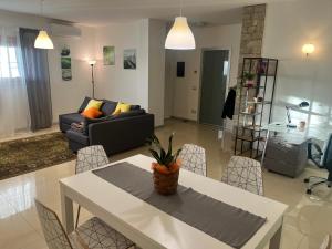 a living room with a table and a couch at Respiro di Bosco in Robbiate