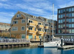 a boat is docked in front of a building at Harborside Inn in Newport