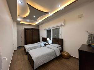 two beds in a room with a room with two at Zaytouna Farm in Ajloun