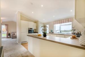 a kitchen with white cabinets and a large counter top at 2 Bed in Evesham oc-f33689 in Admington