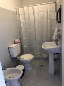 a bathroom with a toilet and a sink at Espacio Marea in Puerto Madryn