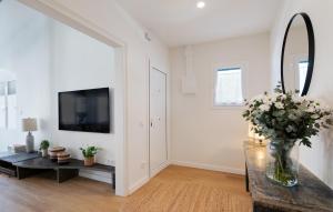 a living room with a vase of flowers on a table at Rosari II - Vivienda Privada con Parking in Vilassar de Mar