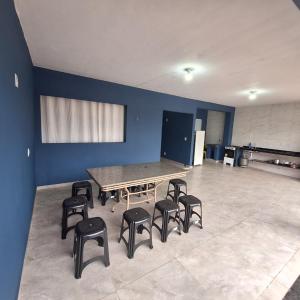 a large room with a table and stools in it at Diony in Brotas