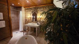 a bathroom with a tub and a sink and a plant at Alte Pfarrey in Neuleiningen +112 photos
