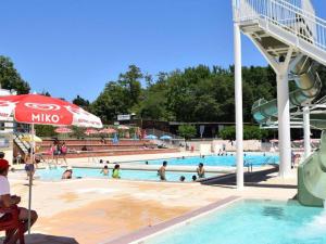 a large swimming pool with people in the water at Chalet 35m² avec Terrasse, 2 Chambres - API-1-52-1014 in Boulogne-sur-Gesse