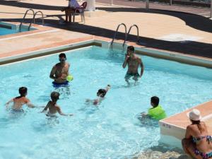 a group of people playing in a swimming pool at Chalet 35m² avec Terrasse, 2 Chambres - API-1-52-1014 in Boulogne-sur-Gesse +12 photos