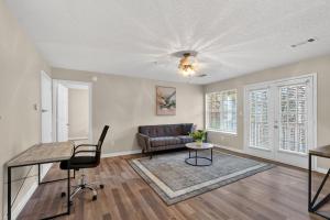a living room with a couch and a table at Bright Stockbridge condo with full kitchen in Stockbridge