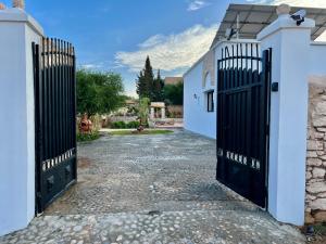 an entrance to a white house with black gates at Villa Serinie in Essaouira