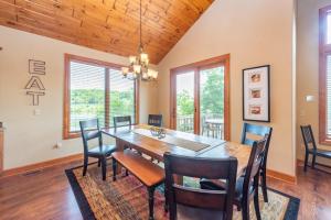 a dining room with a wooden table and chairs at Firefly Cove by Railey Vacations in McHenry