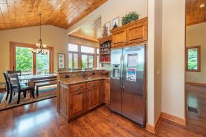 a kitchen with wooden floors and stainless steel appliances at Firefly Cove by Railey Vacations in McHenry