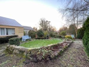 a garden with a bench and a stone wall at Cloonaveel House in Letterbreen