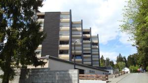 a tall building with a street light in front of it at BEST VIEW Winterberg - Kleines Studio Apartment in Winterberg