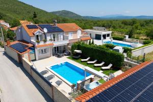 an aerial view of a house with a swimming pool at Villa Peaceful Valley in Šestanovac