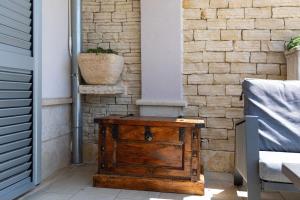 a wooden box sitting on a porch next to a brick wall at Villa Peaceful Valley in Šestanovac