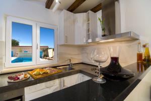 a kitchen with a wine glass sitting on a counter at Villa Peaceful Valley in Šestanovac +58 photos