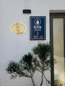 a sign on the side of a building with a plant at Ilya Apart 1 in Bodrum City +39 photos