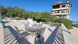 a patio with a table and chairs and a building at Zaytouna Farm in Ajloun