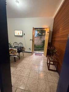 a living room with a door and a table at Refúgio Colonial 3 - Antonio Dias in Ouro Preto