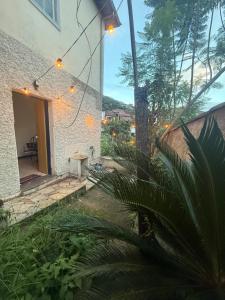 a house with a patio with a table in the yard at Refúgio Colonial 3 - Antonio Dias in Ouro Preto