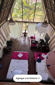a man running in a room with two beds at Top Manu Avatar Lodge in Pillcopata