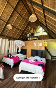 a man standing in a room with two beds at Top Manu Avatar Lodge in Pillcopata
