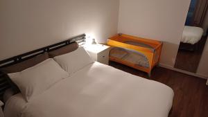 a bedroom with a bed and a night stand with a mirror at Casa Maricciotti in Terni