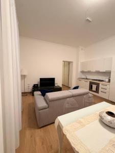 a living room with a couch and a kitchen at PALAZZO MARCHETTI in Ancona