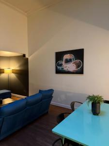 a living room with a blue couch and a table at The Lofts at 107 in Nashville +40 photos