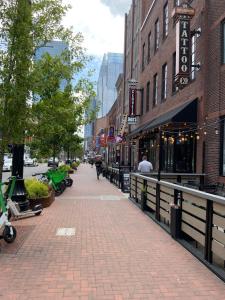a city street with a brick sidewalk and buildings at The Lofts at 107 in Nashville