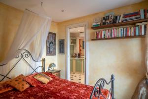 a bedroom with a bed and a book shelf at Romantic Sea View Flat in Genova in Genoa