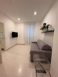 a living room with a couch and a television at PALAZZO MARCHETTI in Ancona
