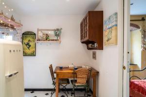 a dining room with a table and a refrigerator at Romantic Sea View Flat in Genova in Genoa +59 photos
