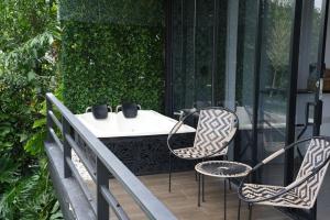 a patio with two chairs and a table on a balcony at Panorama Pueblo Tapao in Armenia