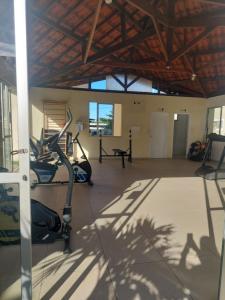 a gym with a treadmill and a elliptical machine at Residencial Clube Recanto dos Coqueiros in Aracaju