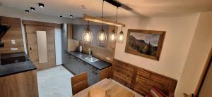 a kitchen with a table and some lights at alter Hannelerhof in Mutters