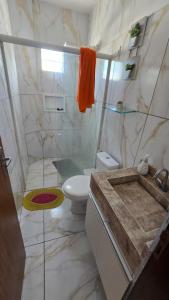 a bathroom with a sink and a toilet at Jacumã Gold in Conde