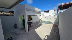 a house with a swimming pool and a patio at Jacumã Gold in Conde