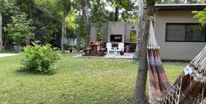 a hammock in a yard next to a house at Quinta con pileta in Brandsen
